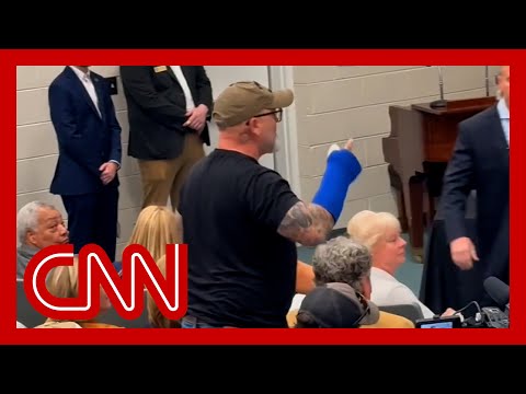 Audience applauds man identifying as a veteran after confronting lawmaker at town hall