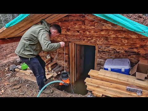 The dugout is flooded, the water is still coming! Pumping out the water! Overnight in a log cabin