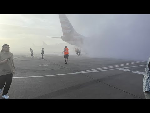 Raw: Passengers run from plane on Denver runway